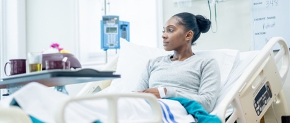 Woman sitting upright on a hospital bed